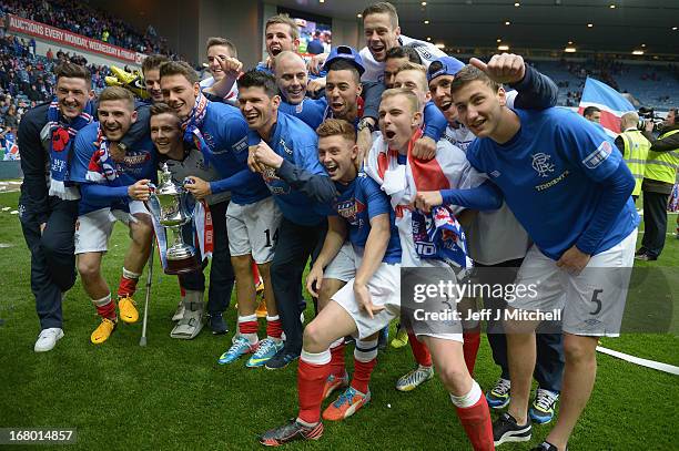 Rangers players celebrate with the IRN - BRU Scottish Third Division trophy following their victory over Berwick Rangers at Ibrox Stadium.