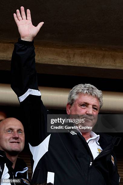 Steve Bruce the Hull manager celebrates following his team's promotion to the Premier League during the npower Championship match between Hull City...