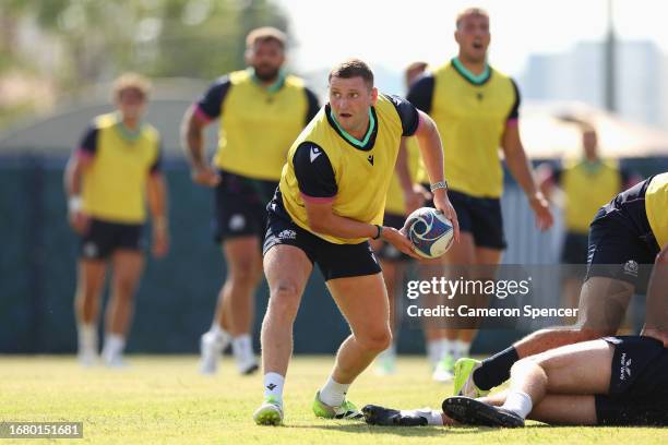 Finn Russell of Scotland passes during a Scotland training session at the Rugby World Cup France 2023 at Stade des Arboras on September 14, 2023 in...