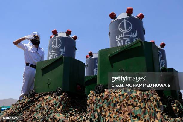 Naval mines are displayed on the back of a vehicle during an official military parade marking the ninth anniversary of the Huthi takeover of the...