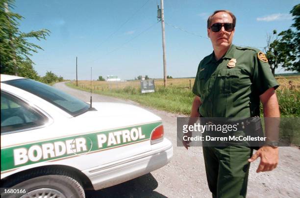 Border Patrol Agent Ross McCart stands along the border with Canada July 26, 2000 in Alsburg Springs, Vermont. Agents say a lack of manpower and...