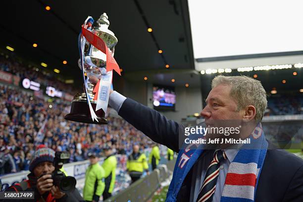 Manager Ally McCoist of Rangers holds the IRN - BRU Scottish Third Division trophy as he shows fans following his team's victory over Berwick Rangers...