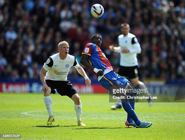 Wilfred Zaha of Palace battles with Craig Alcock of Peterborough during the npower Championship match between Crystal Palace and Peterborough United...