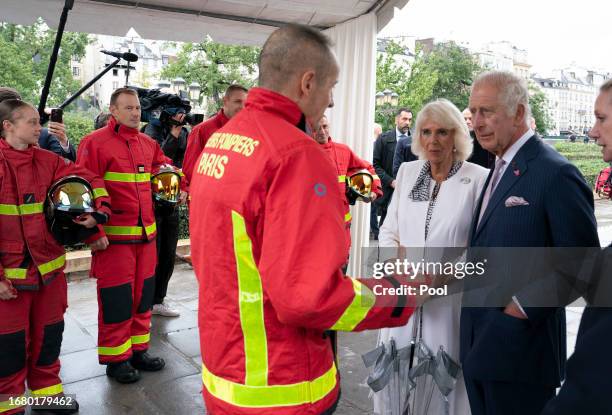 Queen Camilla and King Charles III meet Paris' firefighters during their visit to the Notre-Dame de Paris Cathedral, currently under restoration...