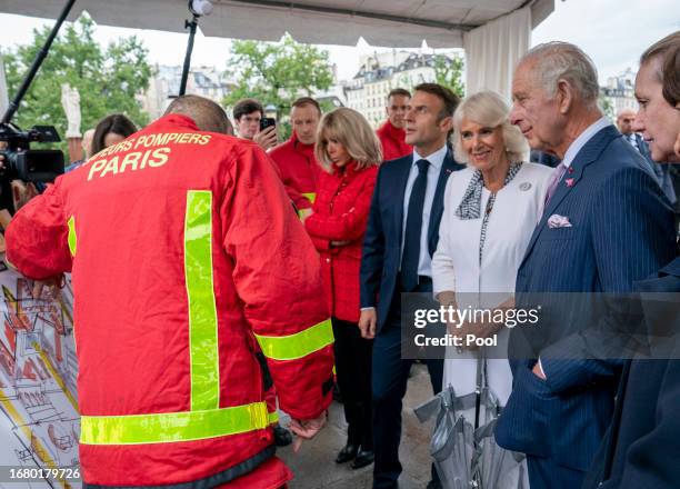 President Emmanuel Macron of France and his wife Brigitte Macron join Queen Camilla and King Charles III as they meet Paris' firefighters during...