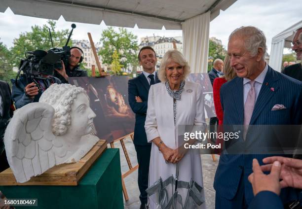 President Emmanuel Macron of France and his wife Brigitte Macron join Queen Camilla and King Charles III as they visit the Notre-Dame de Paris...