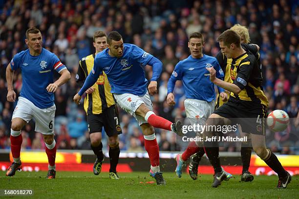 Kane Hemmings of Rangers is tackled by Chris Townsley during the IRN - BRU Scottish Third Division match at Ibrox Stadium on May 4, 2013 in Glasgow,...