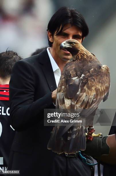 Manager Bruno Huebner of Frankfurt stands next to mascot Attila after the Bundesliga match between Eintracht Frankfurt and Fortuna Duesseldorf 1895...