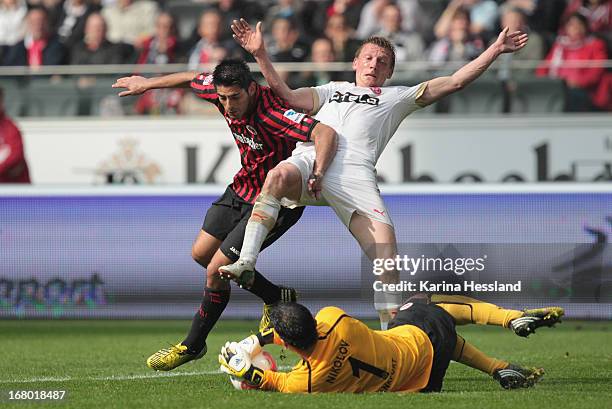 Carlos Zambrano and goalkeeper Oka Nikolov of Frankfurt challenges Maximilian Beister of Duesseldorf during the Bundesliga match between Eintracht...