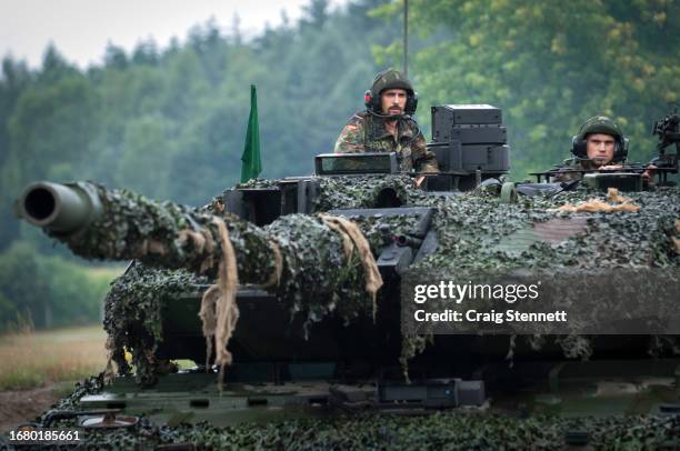 Soldier's commanding their tank crew from the open turret's of a Leopard 2 A6MA2 main battle tank at the Panzerbattalion 414 firing grounds on...