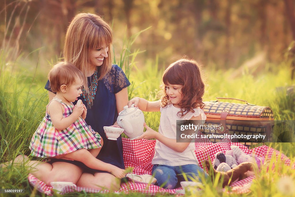 Mother having a tea party with her daughters