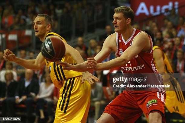 Jan-Hendrik Jagla of Muenchen shoots against Sven Schultze of Berlin during Game 1 of the quarterfinals of the Beko Basketball Playoffs between FC...
