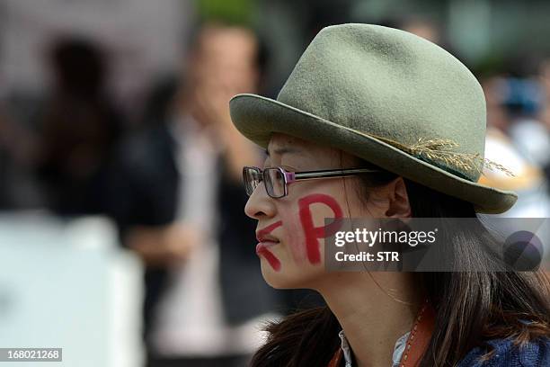 Protester paints "PX" on her face during a demonstration against plans for a factory to produce paraxylene , a toxic petrochemical used to make...