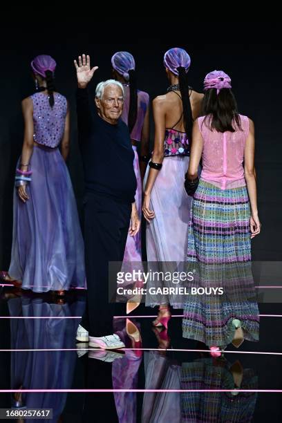 Italian designer Giorgio Armani waves from the runway of the Emporio Armani fashion show during the Milan Fashion Week Womenswear Spring/Summer 2024...
