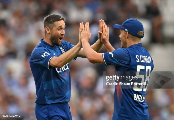 Chris Woakes of England is congratulated by teammate Sam Curran after taking the wicket Henry Nicholls of New Zealand during the 3rd Metro Bank ODI...