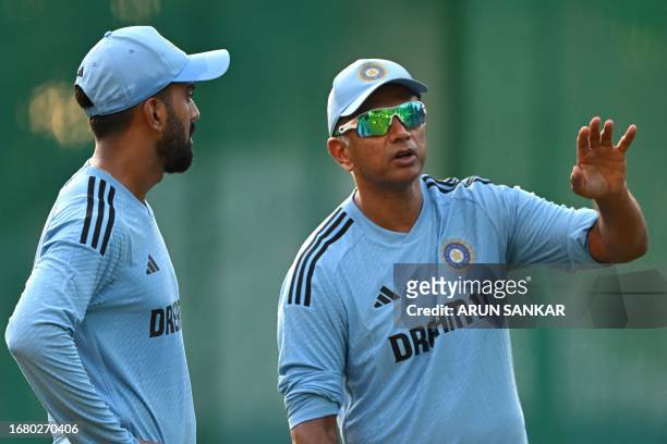 India's coach Rahul Dravid talks with KL Rahul during a practice session at the Punjab Cricket Association I.S. Bindra stadium in Mohali on September...