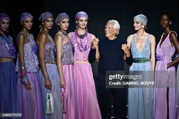 Italian designer Giorgio Armani poses with models on the runway at the end of the Emporio Armani fashion show during the Milan Fashion Week...