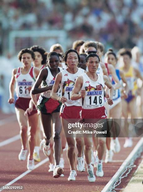 Silver medalist Zhong Huandi from China leads gold medalist compatriot Wang Junxia during the Women's 10,000 Metres race at the 4th International...