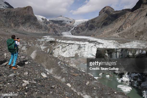 Rupert Schwarzl, a team member with scientists from the University of Graz, snaps a photo of the collapsing terminus of the Pasterze glacier during...