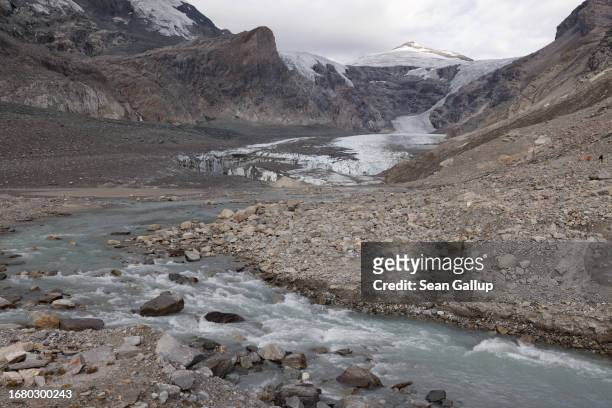 River of meltwater flows from the collapsing terminus of the Pasterze glacier on September 13, 2023 near Heiligenblut, Austria. Scientists from the...