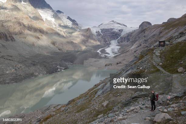 Alexander Doric, a geographer and member of a team of scientists from the University of Graz, looks out onto a lake of meltwater created by the...