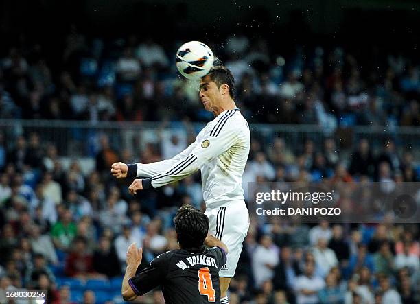 Real Madrid's Portuguese forward Cristiano Ronaldo heads the ball during the Spanish league football match Real Madrid CF vs Valladolid at the...