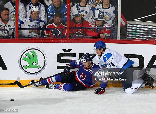 Teemu Laakso of Finland and Tomas Survoy of Slovakia battle for the puck during the IIHF World Championship group H match between Finland and...