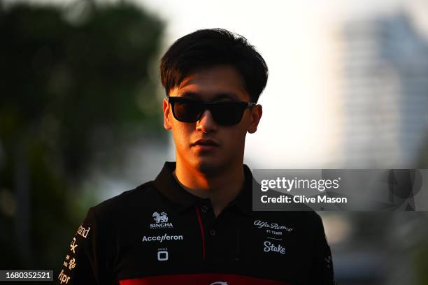 Zhou Guanyu of China and Alfa Romeo F1 walks in the Paddock during previews ahead of the F1 Grand Prix of Singapore at Marina Bay Street Circuit on...