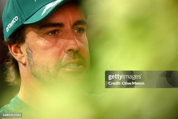 Fernando Alonso of Spain and Aston Martin F1 Team talks to the media in the Paddock during previews ahead of the F1 Grand Prix of Singapore at Marina...
