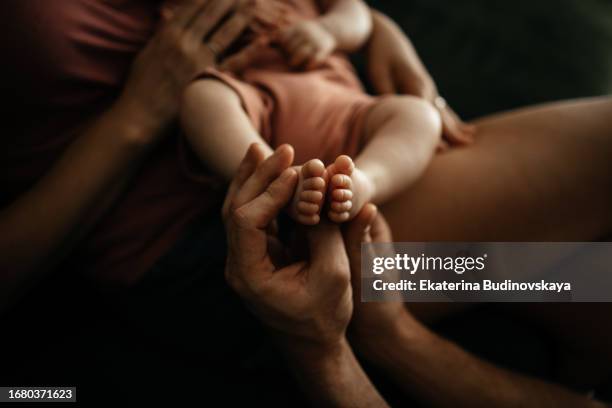 mom holds a newborn baby in her arms - big hug stock pictures, royalty-free photos & images