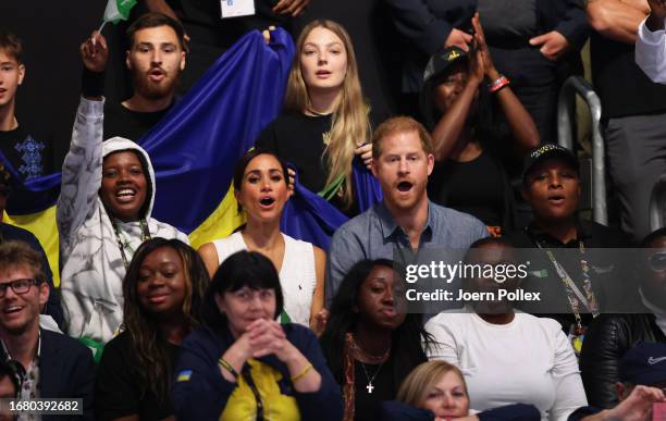 Prince Harry, Duke of Sussex and Meghan, Duchess of Sussex look on during the Mixed Team Preliminary Round - Pool A Sitting Volleyball match between...