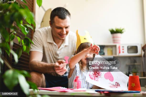 arts and crafts for kids. happy family playing at home. - sparkle children stock pictures, royalty-free photos & images