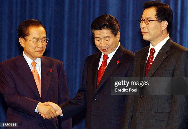 Roh Moo-Hyun , the ruling liberal Millennium Democratic Party's presidential candidate, shakes hands with opposition Grand National Party's...