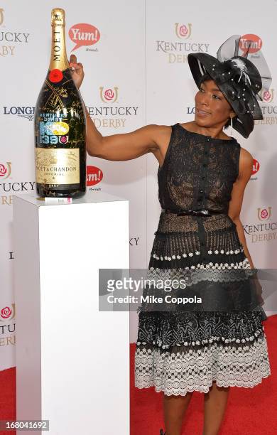 Actress Angela Bassett signs the Moet & Chandon 6L for the Churchill Downs Foundation during the 139th Kentucky Derby at Churchill Downs on May 4,...