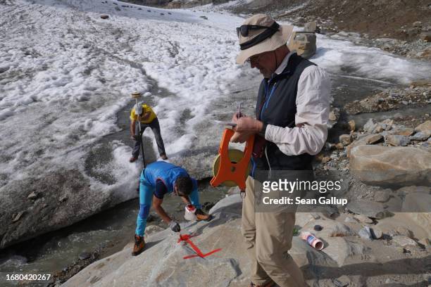 Gerhard Lieb , a geographer with a team of scientists from the University of Graz, directs colleagues as they establish a survey marker for recording...