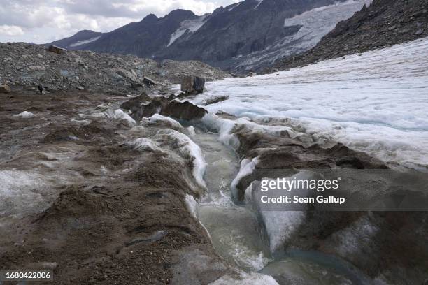 Meltwater flows over ice on an arm of the Pasterze glacier on September 12, 2023 near Heiligenblut, Austria. The Pasterze is losing length and depth...