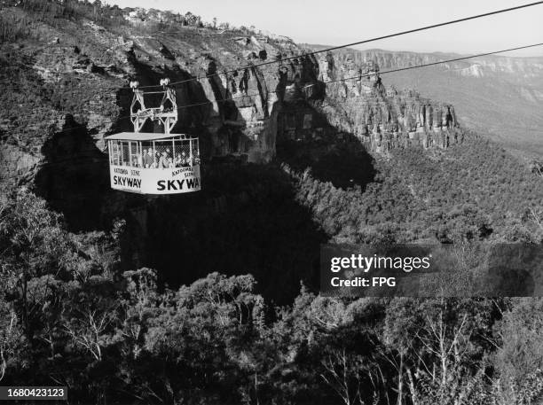 Passengers riding in a Katoomba Scenic Skyway cable car during its 720-metre journey, suspended 270 metres above the ground, offering views of the...