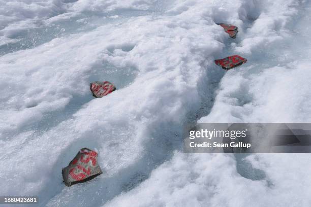 Stone survey markers left by scientists from the University of Graz that they use to asses the rate of ice flow year after year lie on an upper...