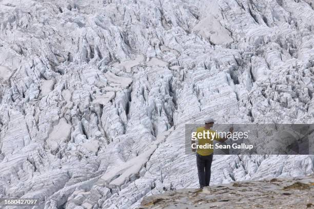 Andreas Kellerer-Pirklbauer-Eulenstein, a geographer at the University of Graz, takes a panorama photo of ice fissures on the upper surface of the...