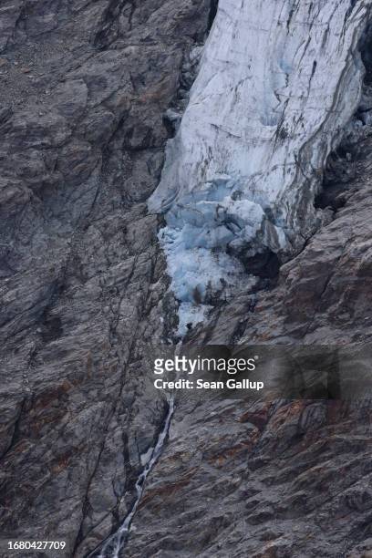 Portion of the Pasterze glacier that once connected to the Pasterze tongue below hangs among rock the glacier once covered on September 12, 2023 near...