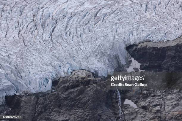 Waterfall descends from an upper portion of the Pasterze glacier over rock the glacier once covered on September 12, 2023 near Heiligenblut, Austria....