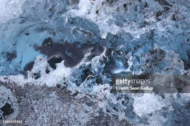 Ice formations and heat-absorbing alpine dust lie on the plateau of the Pasterze glacier on September 12, 2023 near Heiligenblut, Austria. The...