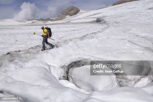 Andreas Kellerer-Pirklbauer-Eulenstein, a geographer at the University of Graz, carries GPS equipment as he walks on the upper surface of the...