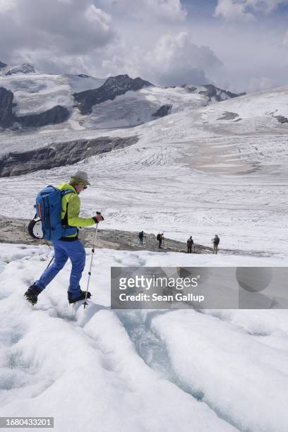 Scientists from the University of Graz walk across the melting plateau of the Pasterze glacier on September 12, 2023 near Heiligenblut, Austria. The...