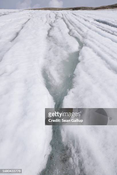 Meltwater rushes down the surface of the plateau of the Pasterze glacier on September 12, 2023 near Heiligenblut, Austria. The Pasterze is losing...