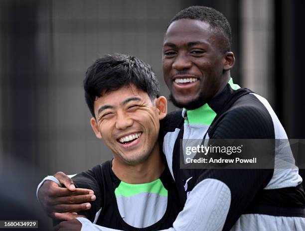 Ibrahima Konate embracing Wataru Endo of Liverpool during a training session at AXA Training Centre on September 14, 2023 in Kirkby, England.