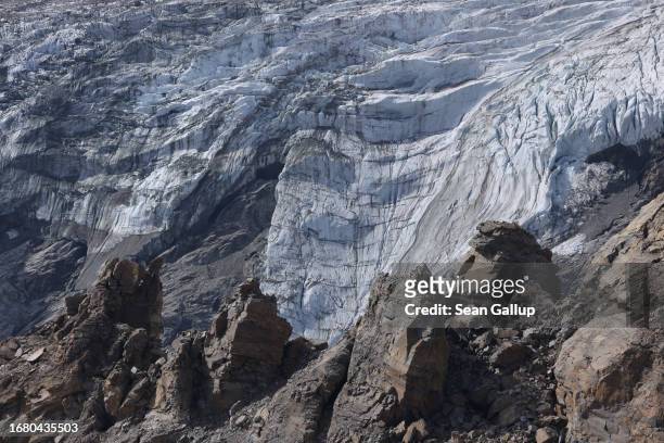 Ice descends from the plateau of the Pasterze glacier behind rock that has become unstable due to thawing permafrost on September 12, 2023 near...