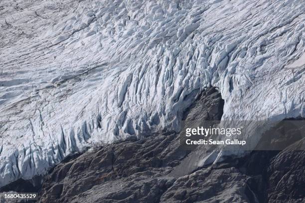 Ice descends from the plateau of the Pasterze glacier over rock the glacier once covered on September 12, 2023 near Heiligenblut, Austria. The...