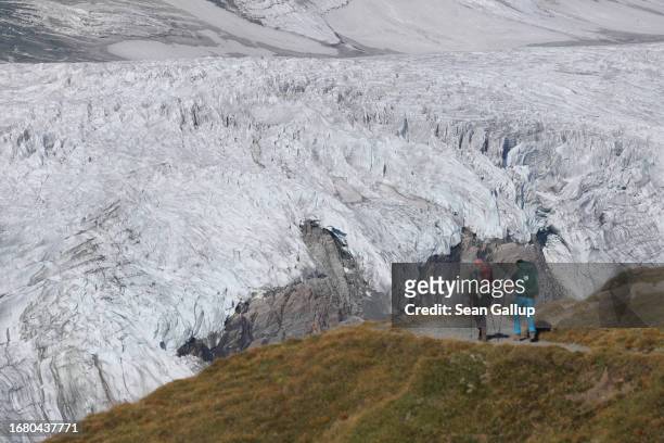 Scientists from the University of Graz hike up towards the plateau of the Pasterze glacier on September 12, 2023 near Heiligenblut, Austria. The...