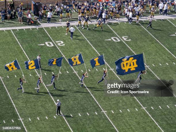 The Notre Dame Fighting Irish male cheerleaders spell out "Irish" with flags after scoring a field goal during the college football game between the...